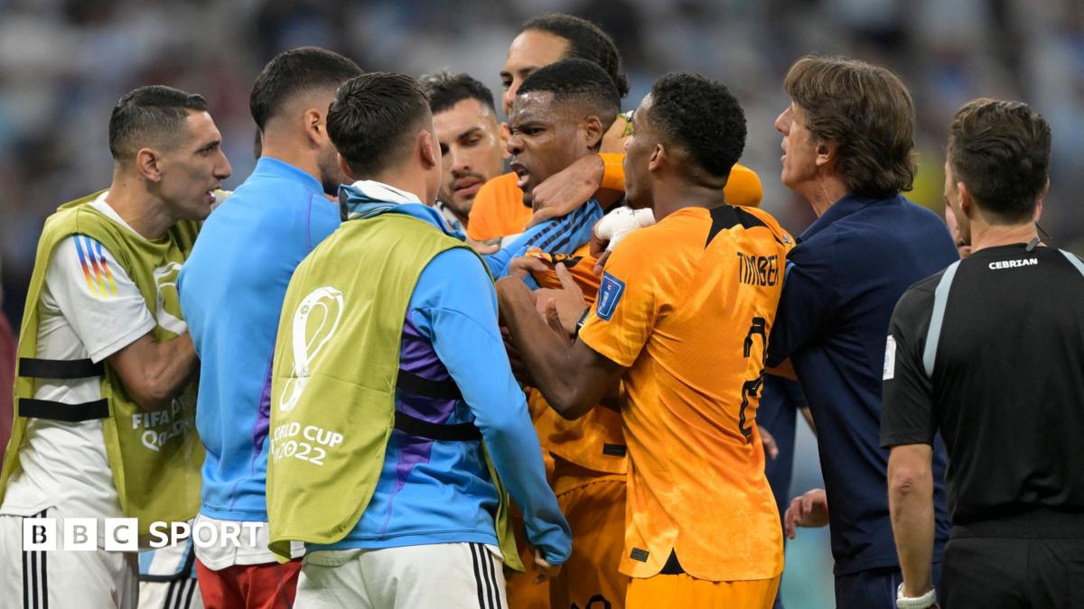 Players clash beside the Netherlands bench during the 2022 World Cup quarter-final
